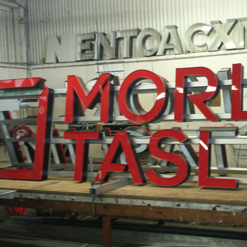 Tower Crane Signs made by Dee Sign. We fabricate framing behind lightweight channel letters creating a strong sign for mounting on cranes. Low voltage LED with a photo cell for automatic on and off.
