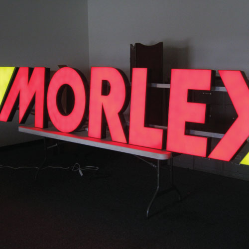 Tower Crane Signs made by Dee Sign. We fabricate framing behind lightweight channel letters creating a strong sign for mounting on cranes. Low voltage LED with a photo cell for automatic on and off.